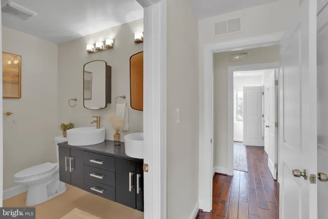 a bathroom with a toilet sink and mirror