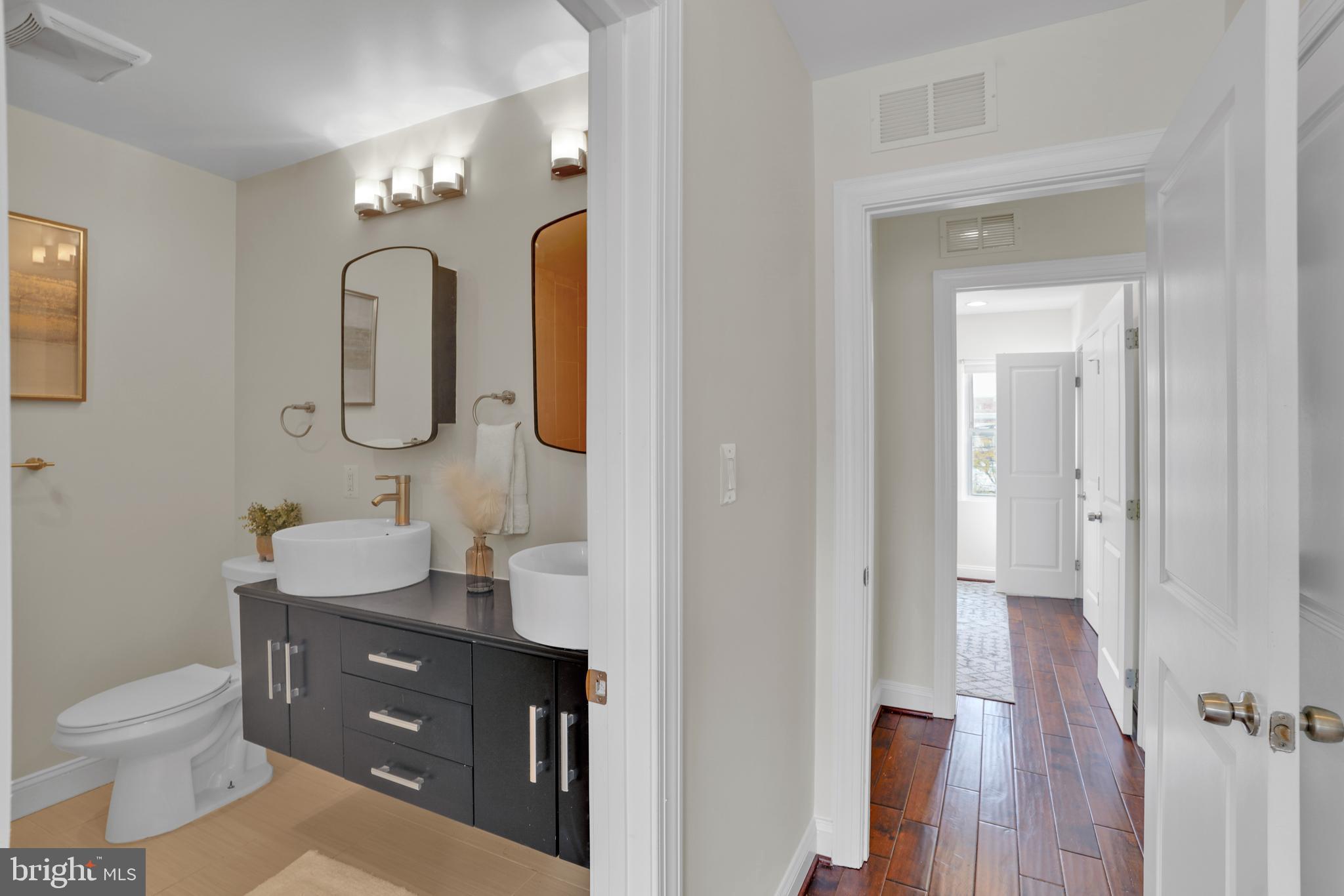 5132 7th Street Northwest Washington, DC 20011 - Photo 14 of 34 a bathroom with a toilet sink and mirror