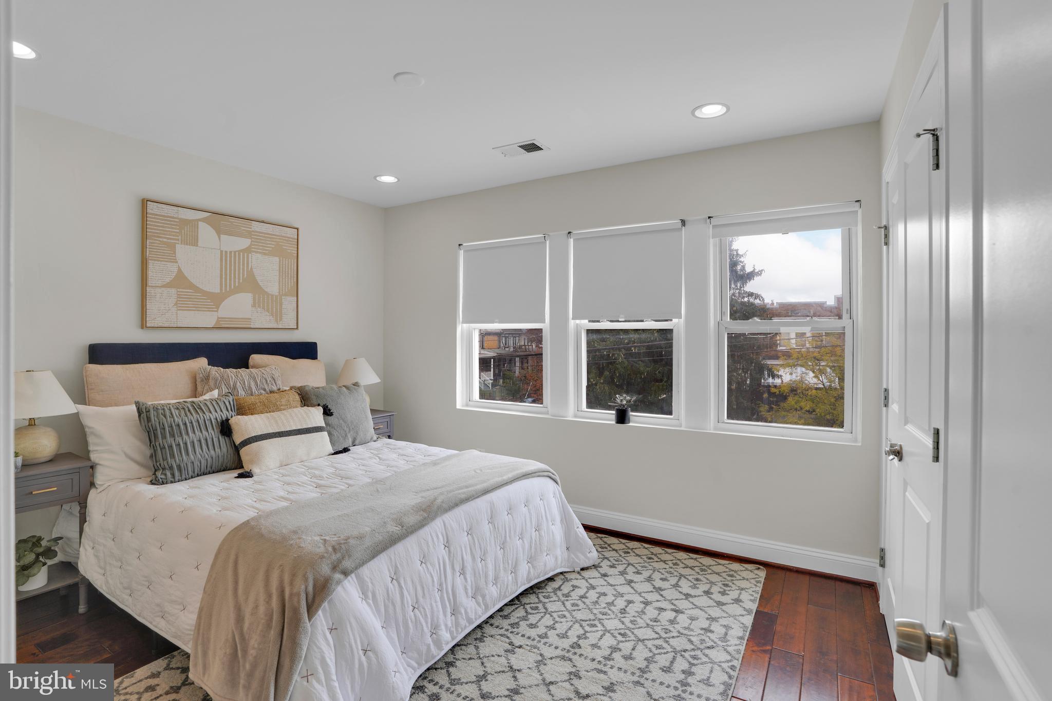 5132 7th Street Northwest Washington, DC 20011 - Photo 17 of 34 a bedroom with a large bed and a window