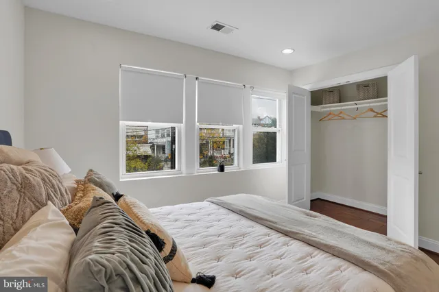 a bedroom with a bed and a window