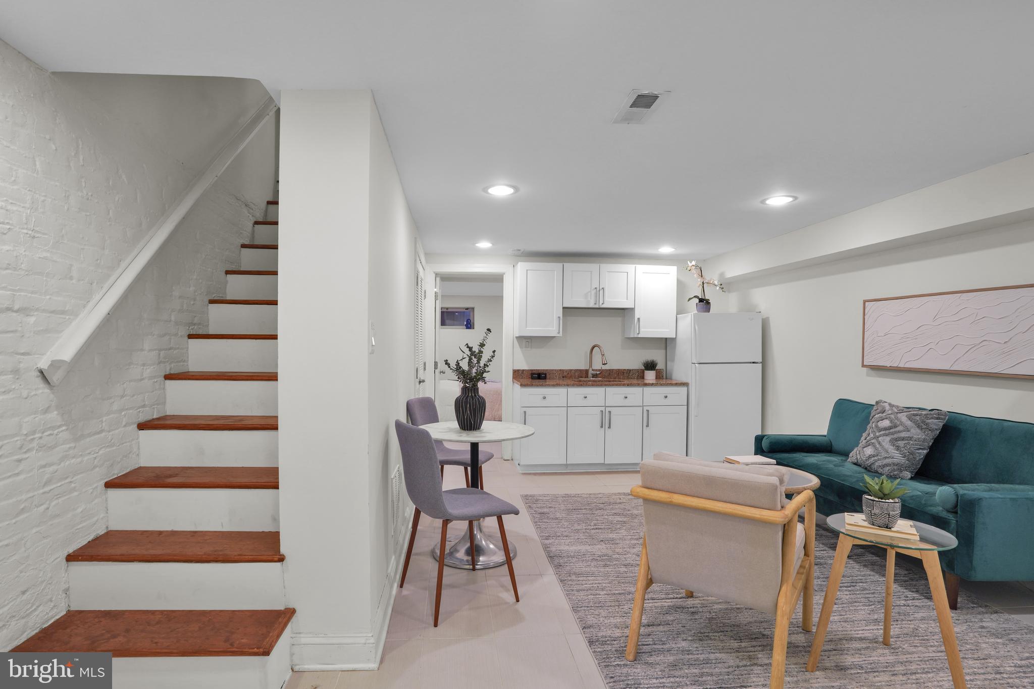 5132 7th Street Northwest Washington, DC 20011 - Photo 21 of 34 a living room with furniture and kitchen view with wooden floor