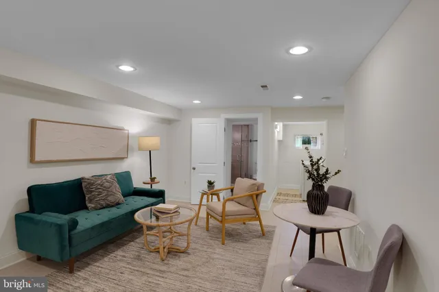 a living room with furniture and a potted plant