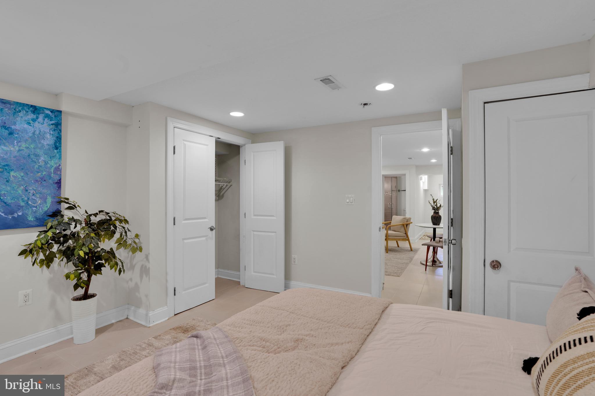 5132 7th Street Northwest Washington, DC 20011 - Photo 25 of 34 a bedroom with a bed and a potted plant