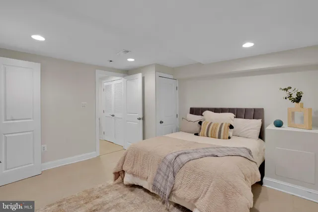 a bed room with a bed and a night stand