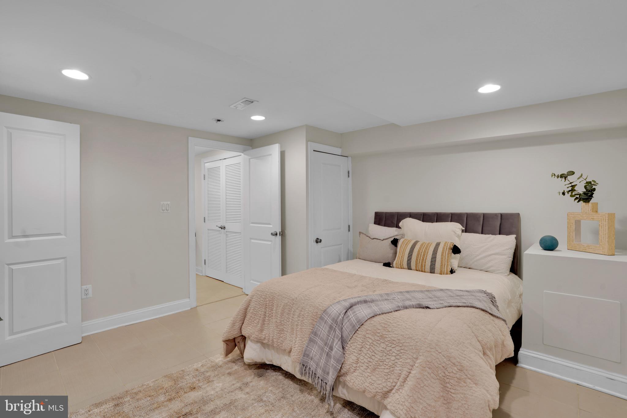 5132 7th Street Northwest Washington, DC 20011 - Photo 26 of 34 a bed room with a bed and a night stand