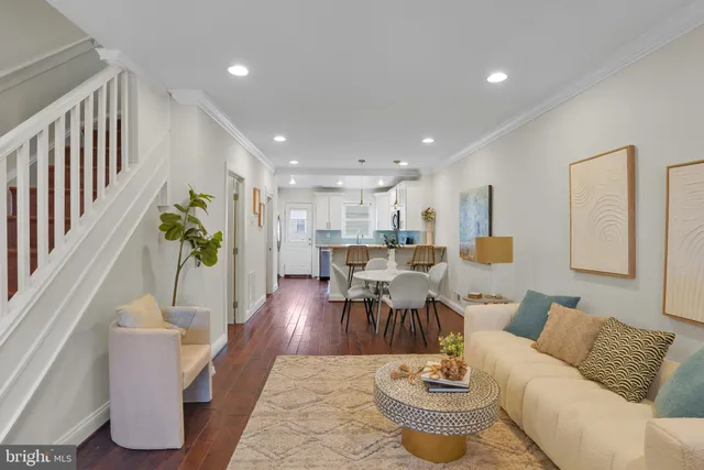 a living room with furniture and a dining table with garden view
