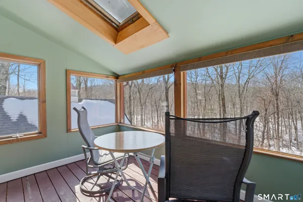 a balcony with table and chairs