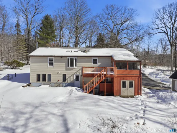 a view of a house with a yard covered with snow in the backyard
