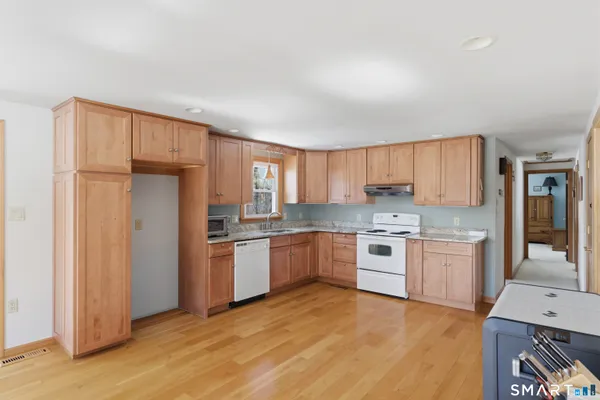 a kitchen with a refrigerator stove top oven and sink