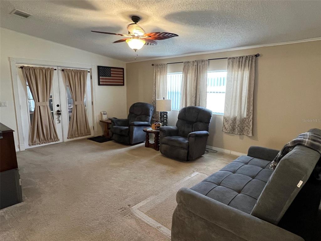 1001 Starkey Road, Unit 731 Largo, FL 33771 - Photo 12 of 35 a living room with furniture ceiling fan and a window