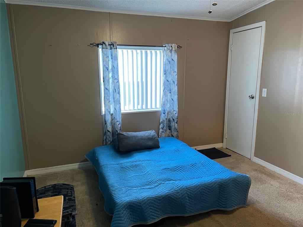 1001 Starkey Road, Unit 731 Largo, FL 33771 - Photo 29 of 35 a bedroom with a bed and window