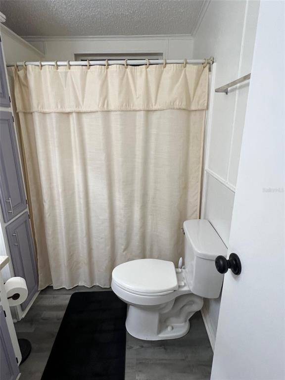 1001 Starkey Road, Unit 731 Largo, FL 33771 - Photo 32 of 35 a white toilet sitting next to a shower curtain