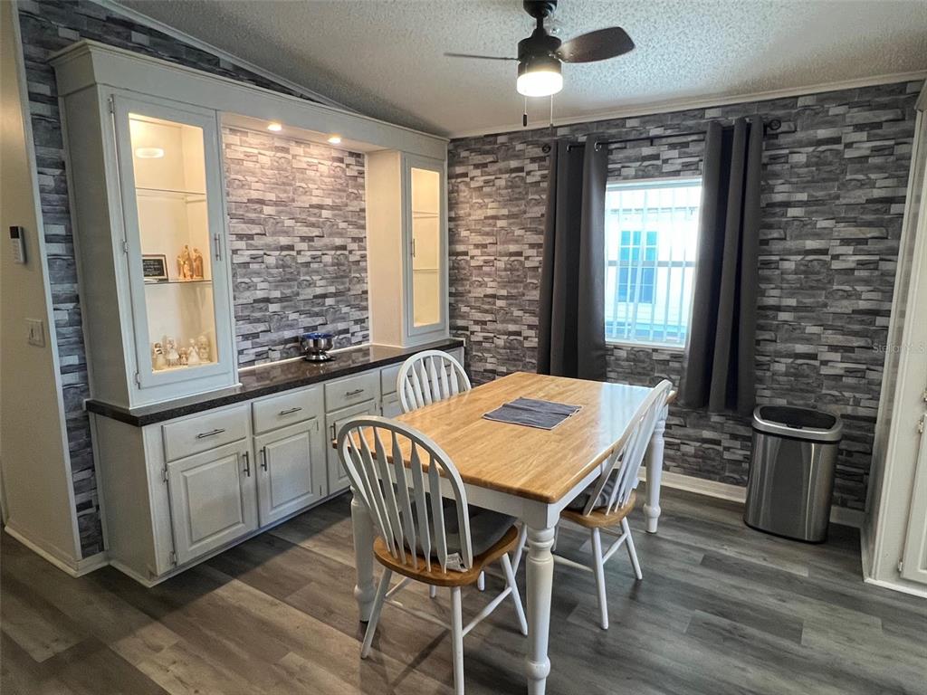 1001 Starkey Road, Unit 731 Largo, FL 33771 - Photo 4 of 35 a view of a dining room with furniture window and wooden floor