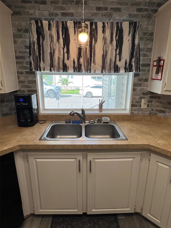 1001 Starkey Road, Unit 731 Largo, FL 33771 - Photo 7 of 35 a kitchen with a sink and cabinets