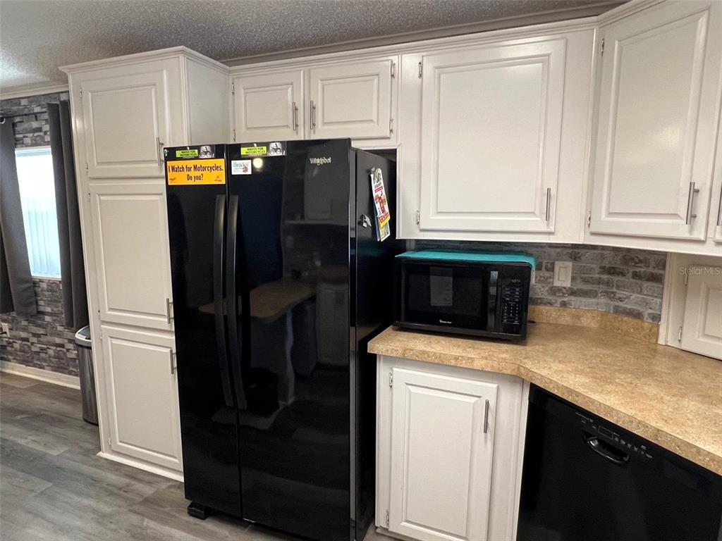1001 Starkey Road, Unit 731 Largo, FL 33771 - Photo 9 of 35 a kitchen with a refrigerator and cabinets