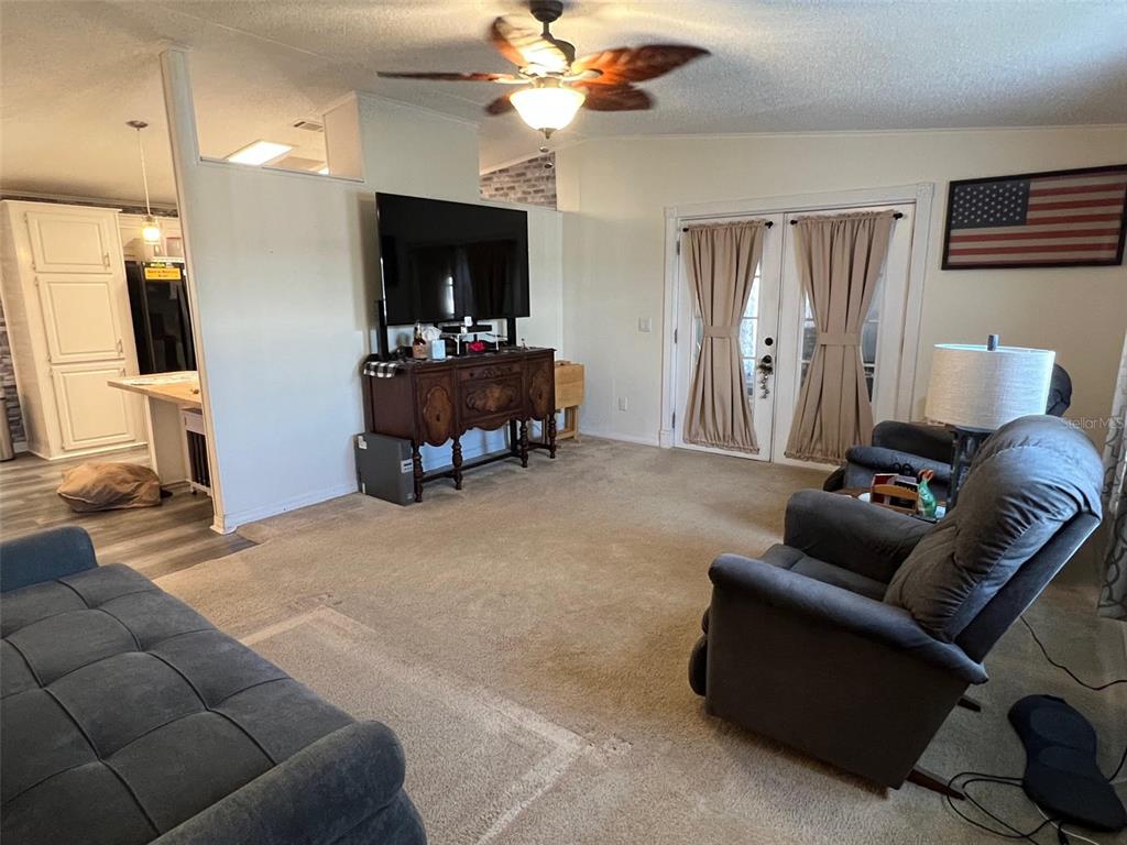 1001 Starkey Road, Unit 731 Largo, FL 33771 - Photo 10 of 35 a living room with furniture and a flat screen tv
