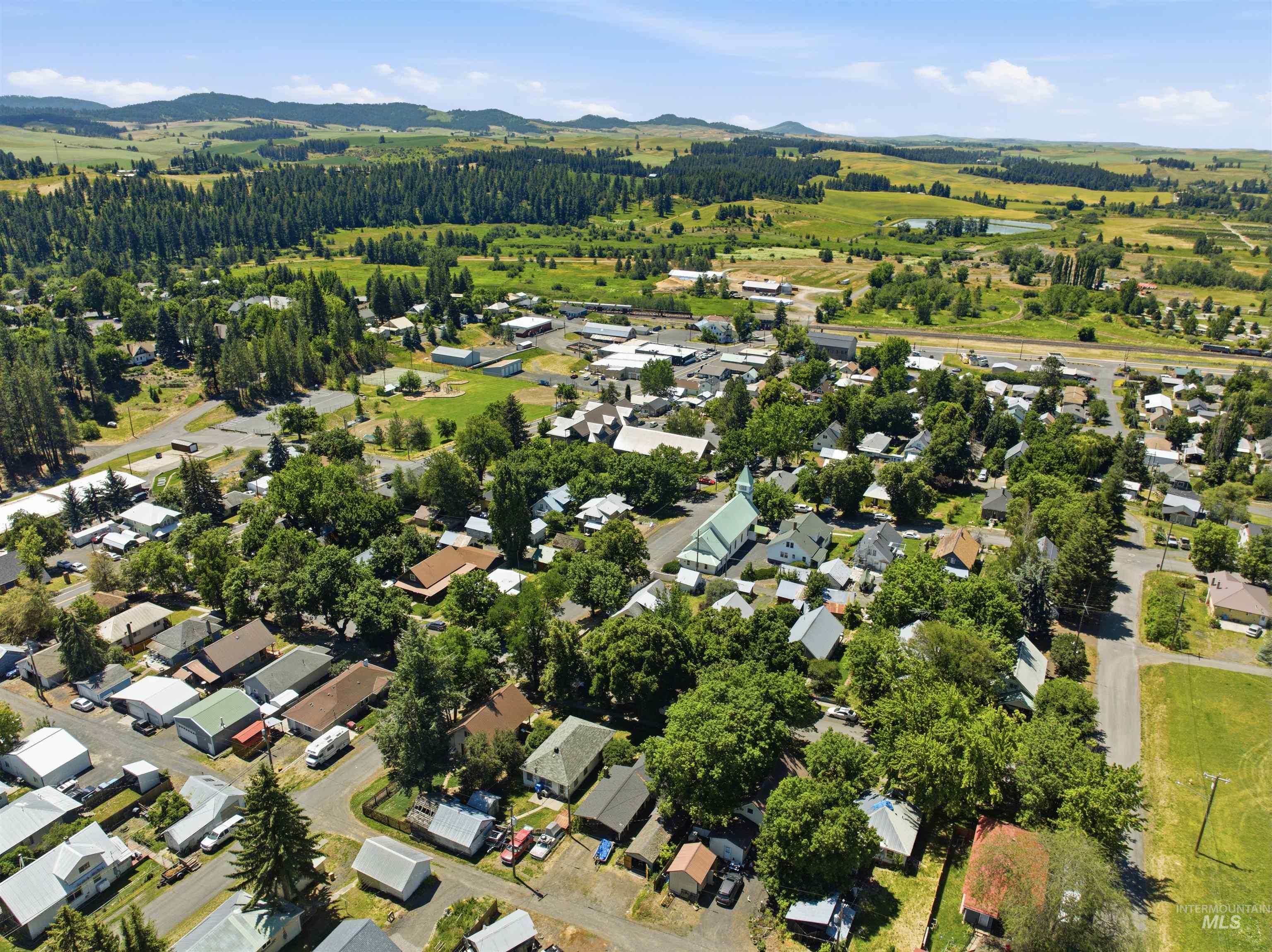 735 Oak Street Potlatch, ID 83855 - Photo 27 of 30 Aerial perspective showcasing residential properties within a verdant setting