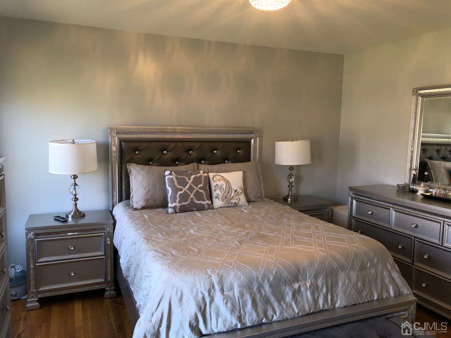 117 Princeton Road Old Bridge, NJ 08859 - Photo 14 of 19 a bedroom with a bed and a lamp on table