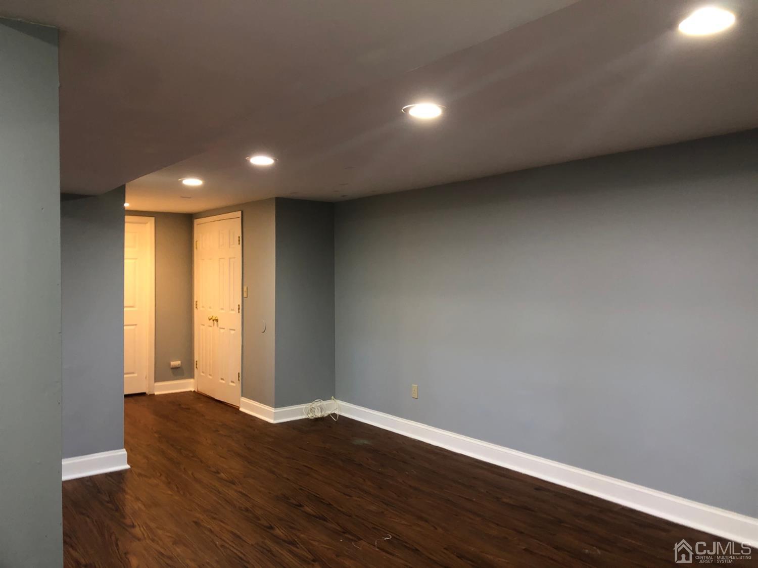 117 Princeton Road Old Bridge, NJ 08859 - Photo 17 of 19 a view of an empty room with wooden floor and a window