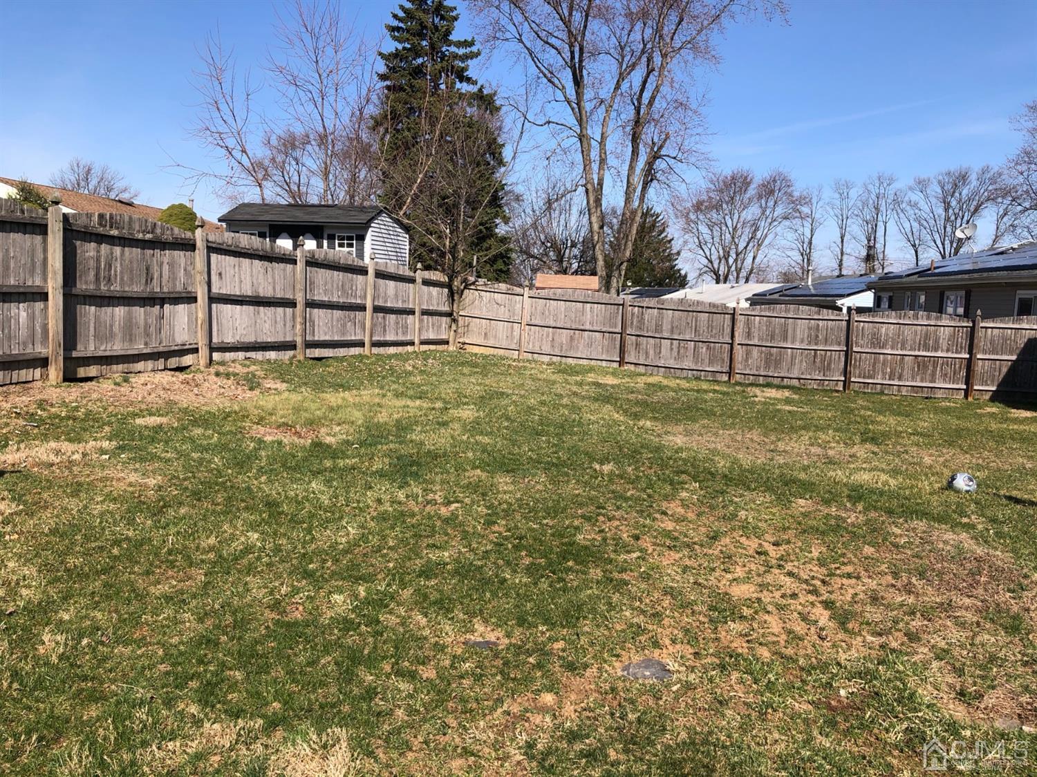 117 Princeton Road Old Bridge, NJ 08859 - Photo 4 of 19 a view of backyard with wooden fence