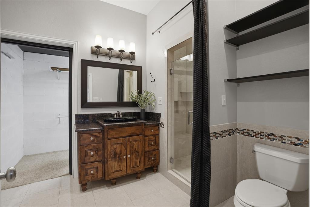 9651 Yellow Rose Lane Pilot Point, TX 76258 - Photo 20 of 38 a bathroom with a toilet sink and mirror