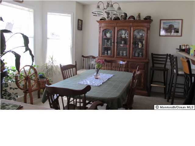 424 Diamond Road Jackson, NJ 08527 - Photo 3 of 22 a black and white photo of a dining room with furniture and window
