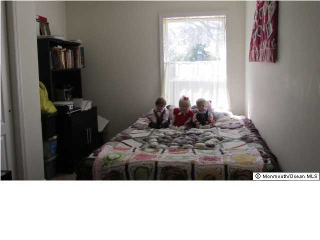 424 Diamond Road Jackson, NJ 08527 - Photo 9 of 22 a black and white bed sitting in a bedroom next to a window