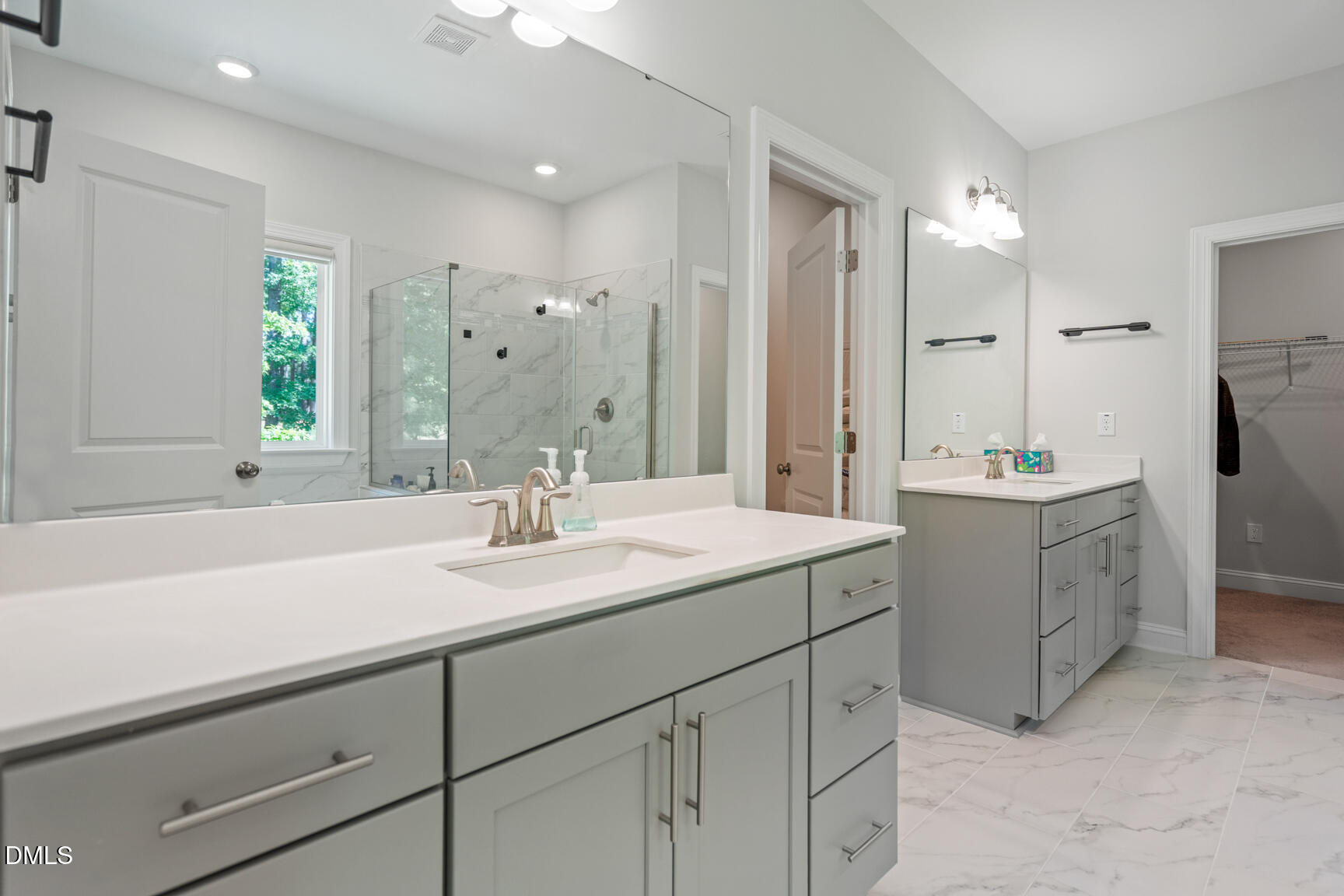 2966 Rise And Shine Road Apex, NC 27502 - Photo 32 of 61 a bathroom with a sink double vanity granite tub shower and a mirror
