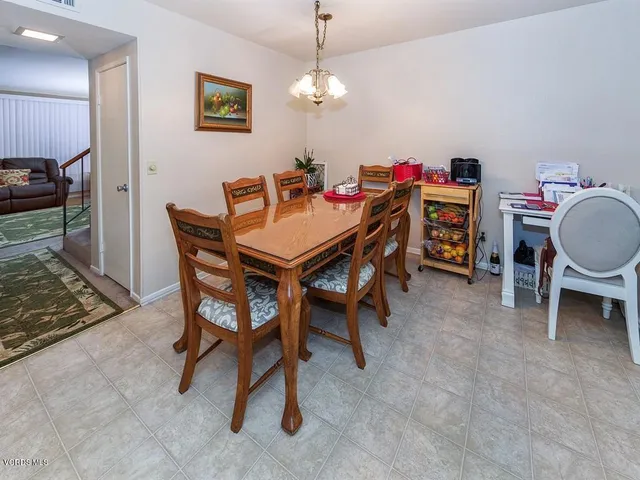 a view of a dining room with furniture and chandelier