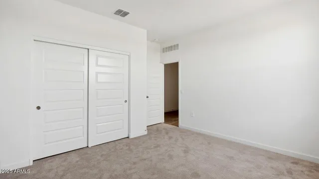 an empty room with closet area