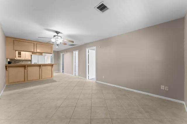 a view of a kitchen with a sink and chandelier fan