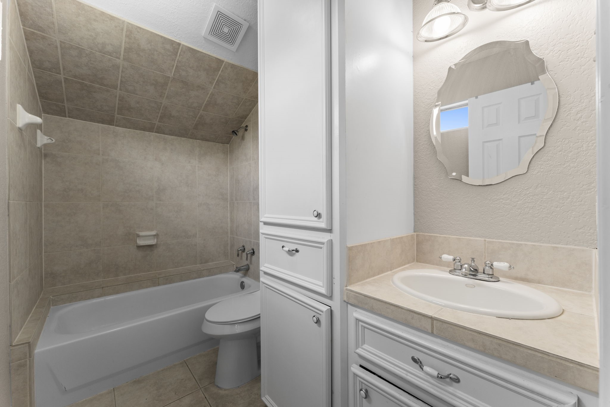 3145 Frick Road Houston, TX 77038 - Photo 8 of 10 a bathroom with a granite countertop sink a toilet and a bathtub