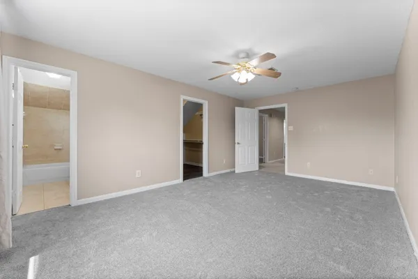 a view of an empty room with a fan