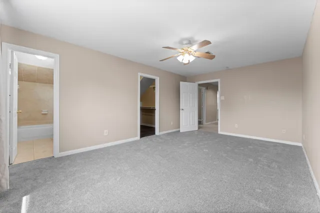 a view of an empty room with a fan