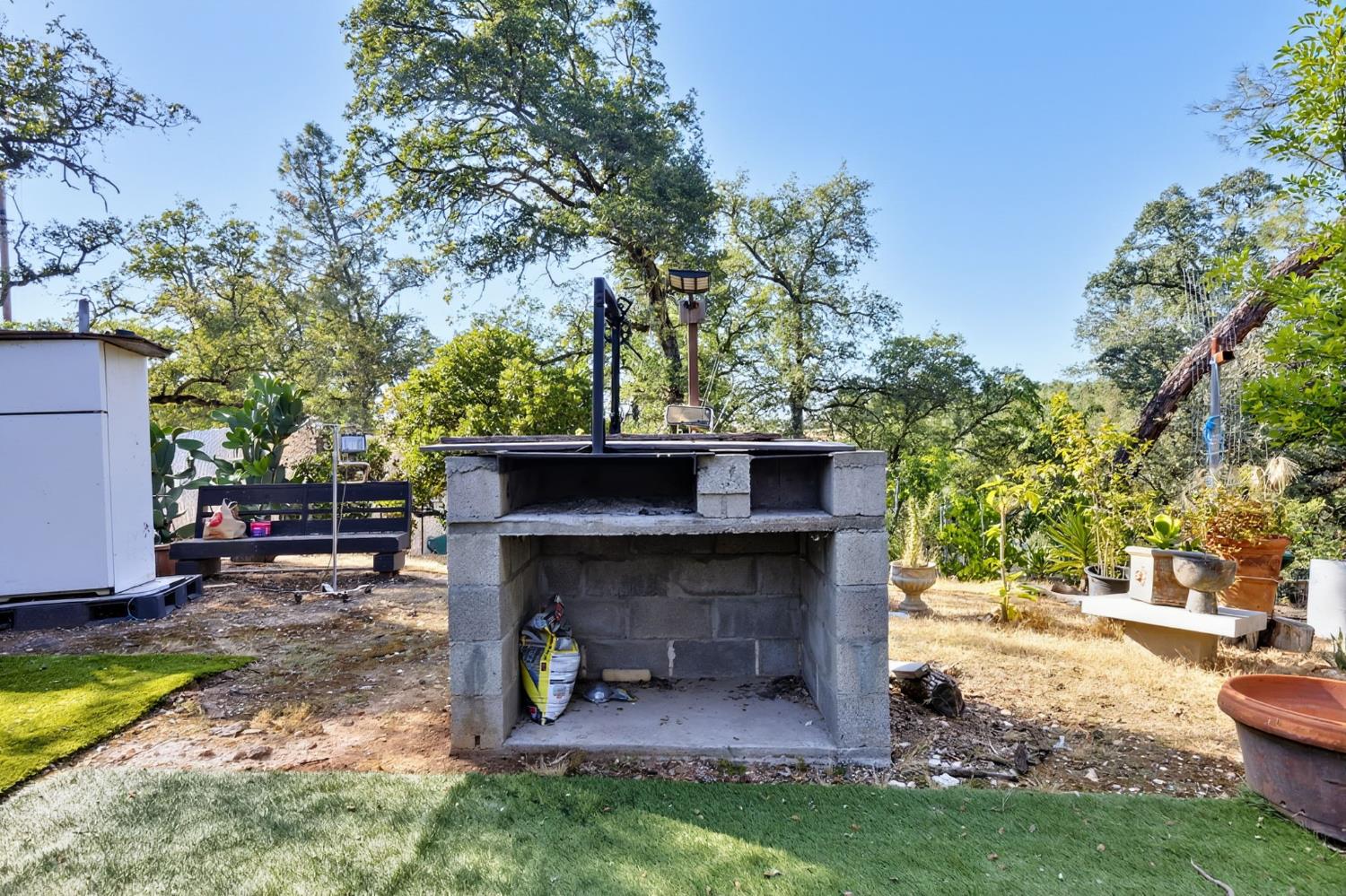 5263 Chile Camp Road Campo Seco X, CA 95226 - Photo 21 of 24 a view of a yard with a fire pit and a large tree
