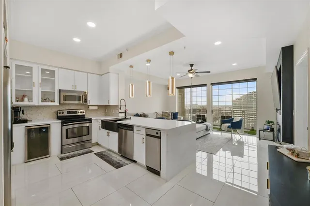 a kitchen with appliances a sink and cabinets