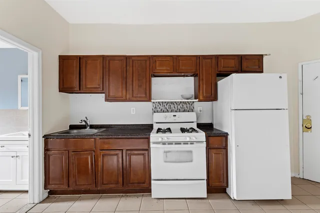 a kitchen with a stove and a refrigerator