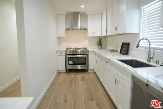a kitchen with a sink stove and cabinets
