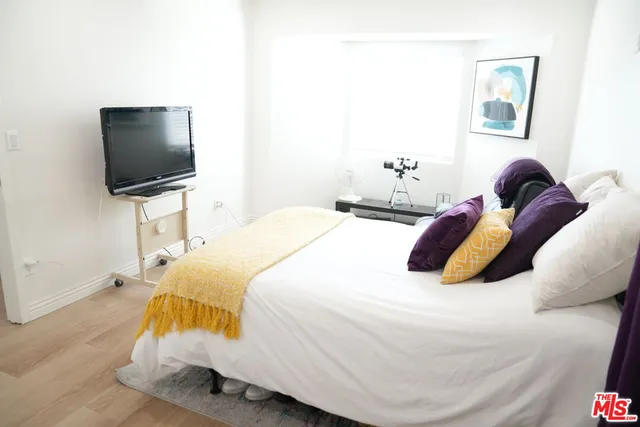 a bedroom with a bed and a flat screen tv