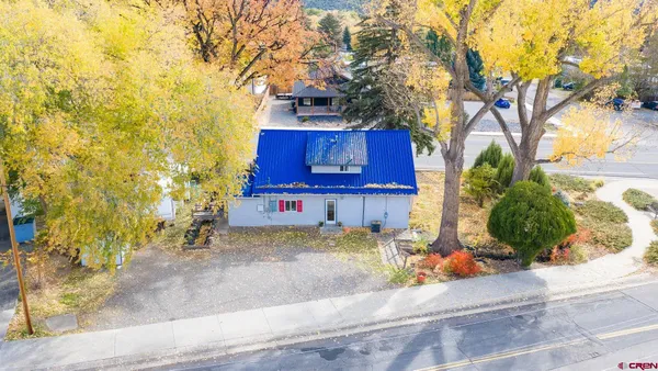 a living room with furniture and a lamp