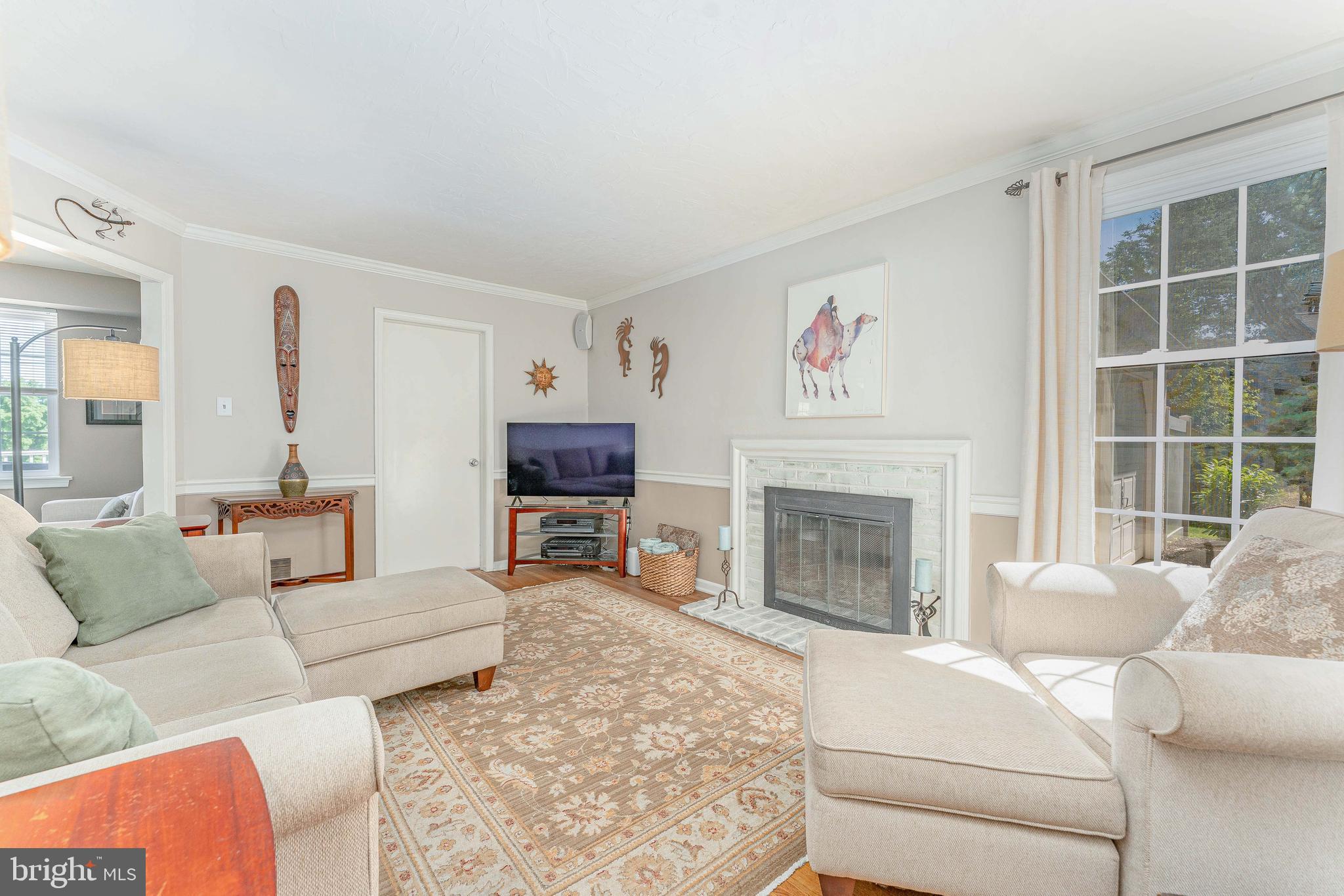 84 North Spring Lane Phoenixville, PA 19460 - Photo 22 of 51 a living room with furniture a fireplace and a large window