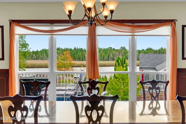 a view of a bedroom with furniture and a window