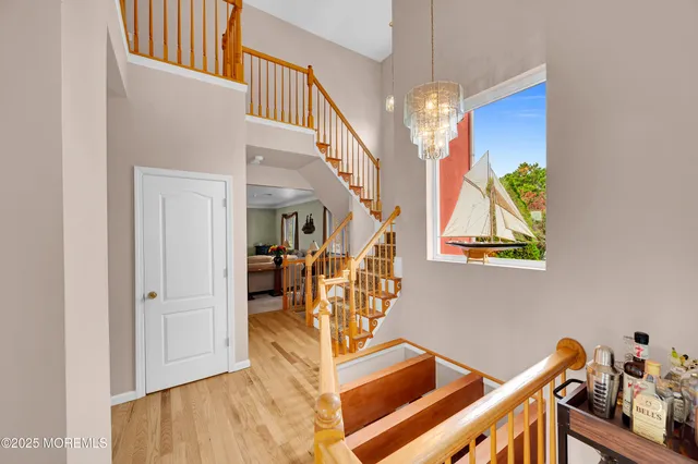 a spacious bedroom with a bed a mirror and a large window