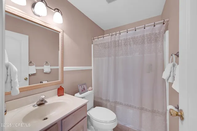a view of a patio with table and chairs potted plants and large tree