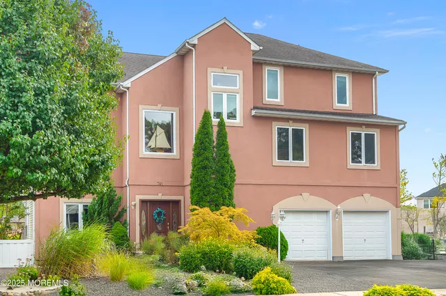 a kitchen with stainless steel appliances granite countertop white cabinets granite counter tops and a window