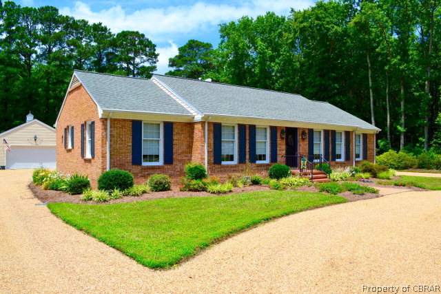 10306 Buckley Hall Road Mathews, VA 23109 - Photo 1 of 22 a front view of a house with a yard