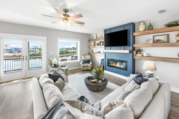 a living room with furniture a fireplace and a flat screen tv