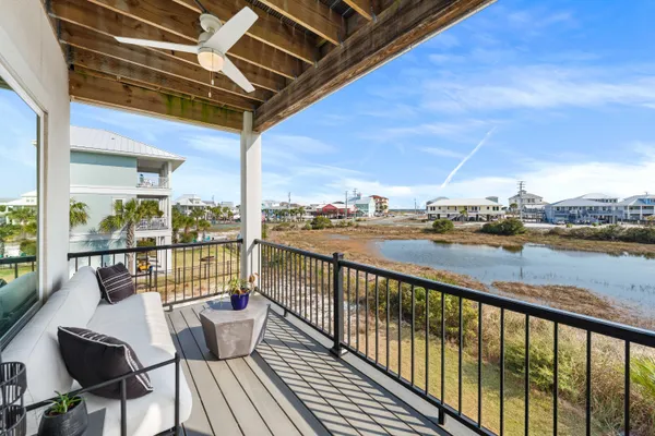 a view of kitchen with stainless steel appliances granite countertop dining table chairs and a chandelier