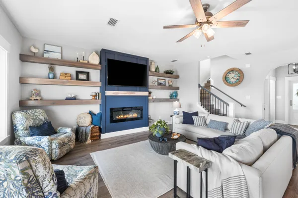 a kitchen with stainless steel appliances granite countertop a sink a stove and a wooden floors