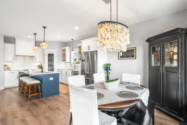 a large kitchen with a table and chairs